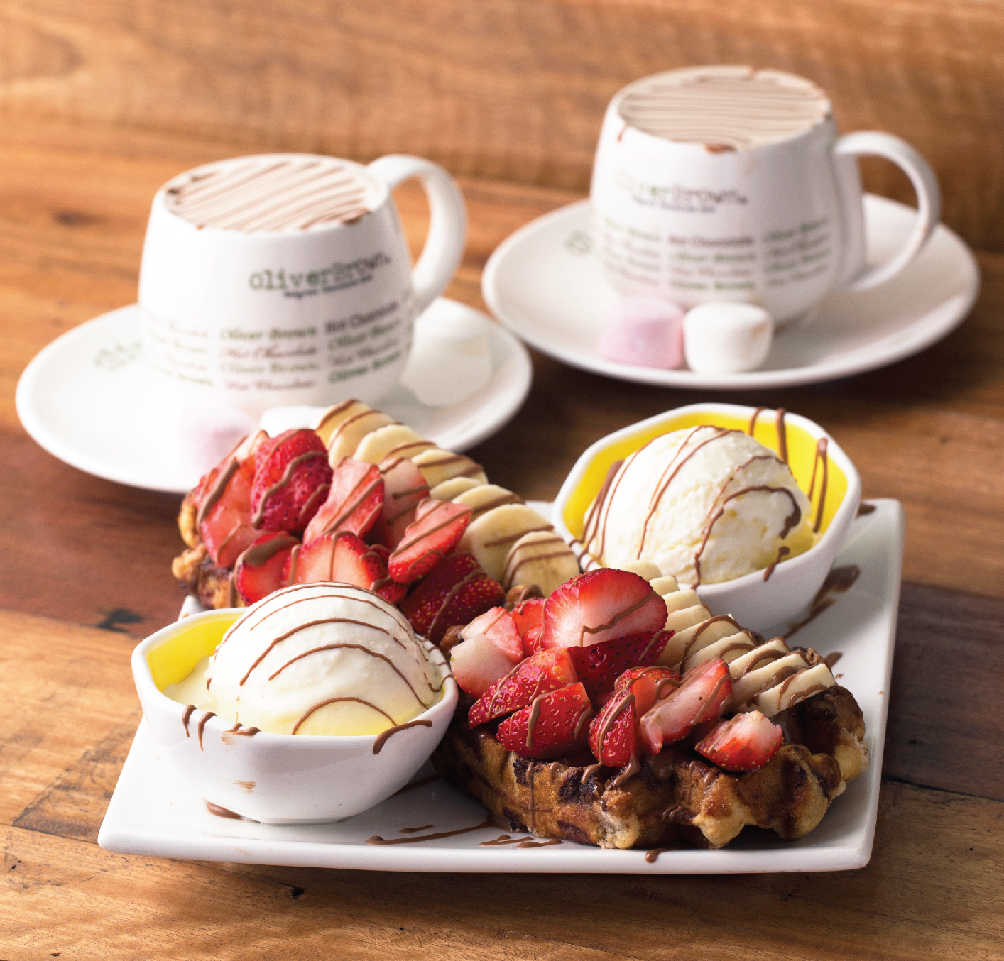 Waffles with strawberries, ice cream and hot chocolate